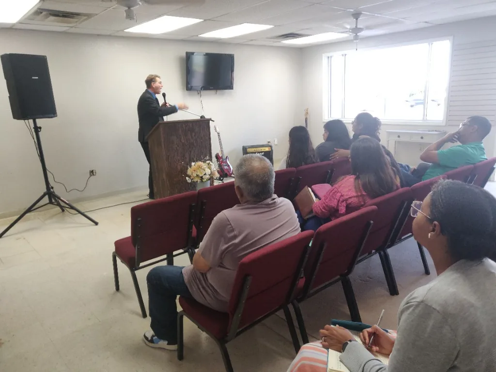 Pastor Edward May preaching at The Door Beeville's first service