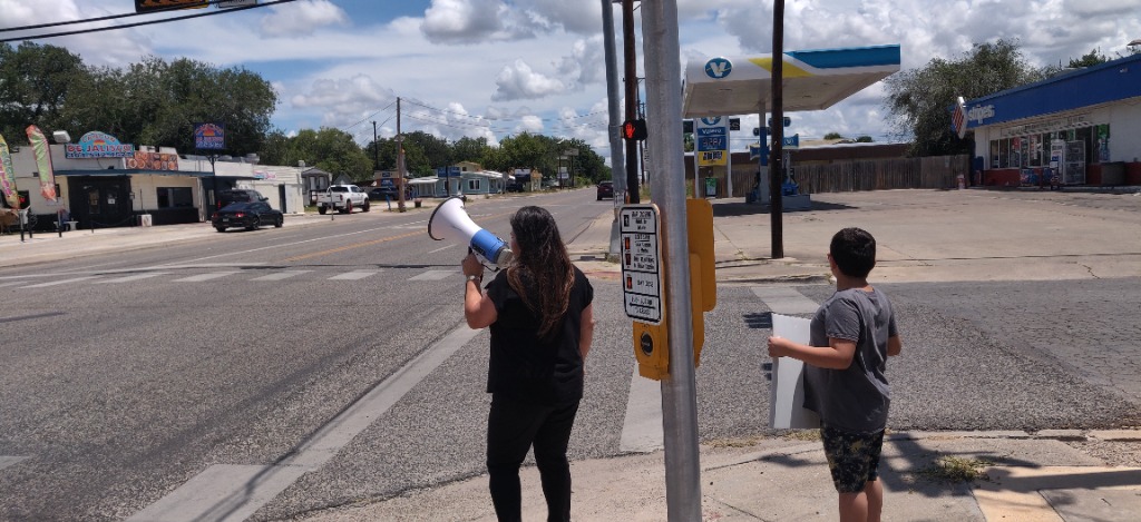 Member using a megaphone to share the Gospel in Beeville